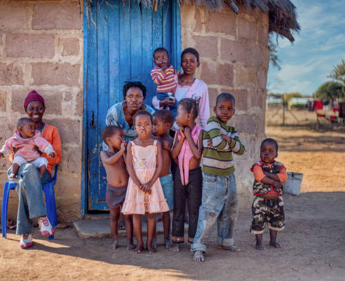 Family life group of African kids and mother in a village in Botswana Feed the Future: Food Security for Widows and Orphaned Children
